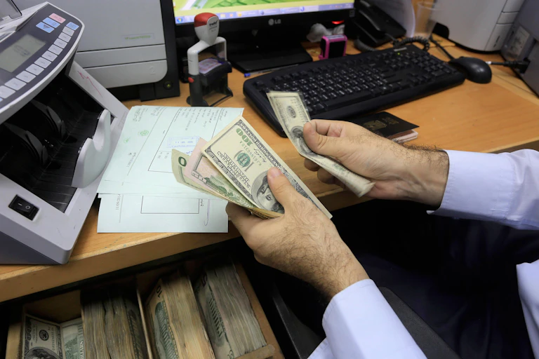 A man counting dollar bills.