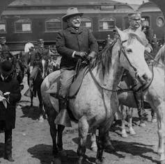 Roosevelt on horseback looking elated.