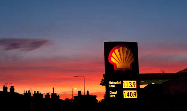 Shell petrol station sign against sunset sky
