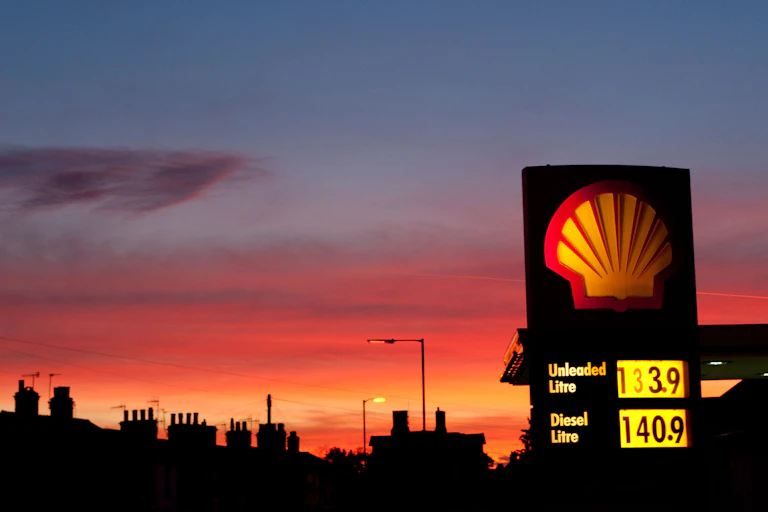 Shell petrol station sign against sunset sky