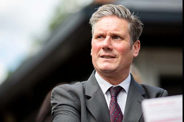 Labour leader Keir Starmer in grey suit and purple tie.