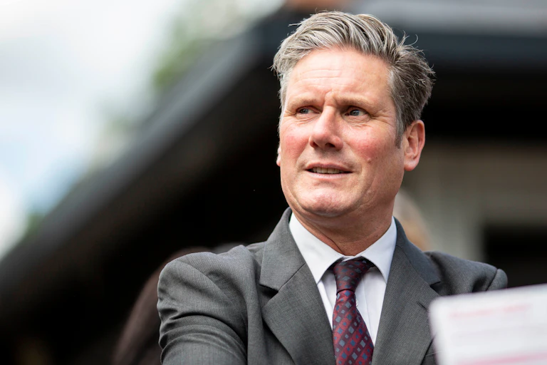 Labour leader Keir Starmer in grey suit and purple tie.