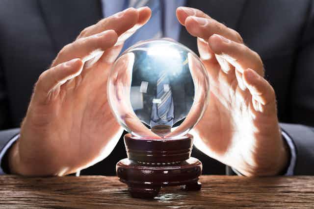 Crystal ball with man's hands surrounding it