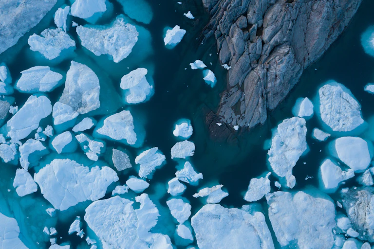 Drone aerial image of icebergs from a melting glacier in an icefjord in Greenland