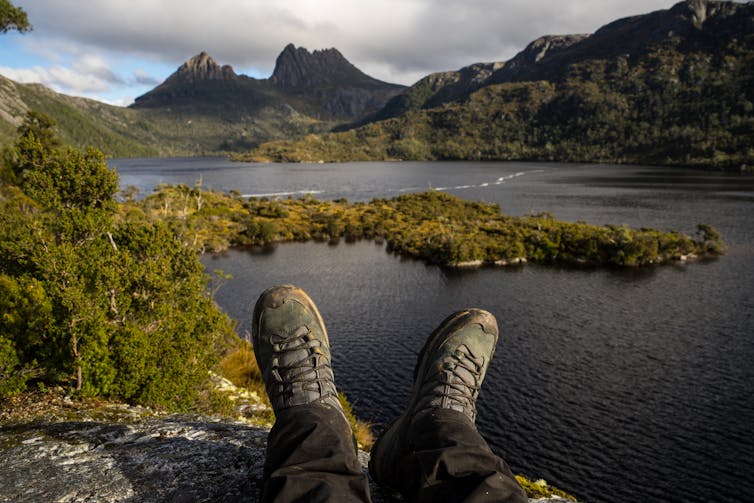 Hiking boots overlooking a lake in Cradle Mountain