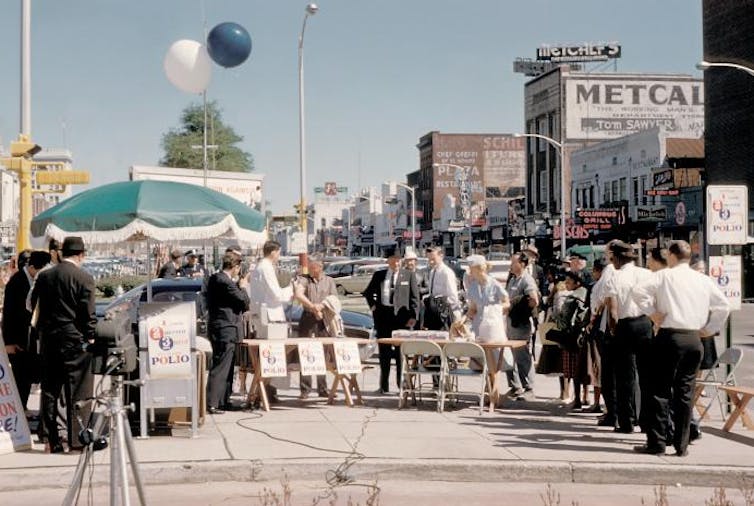 This historic image depicts a gathering of people in Columbus, Georgia, who were awaiting their polio vaccination, during the earlier days of the National Polio Immunization Program.