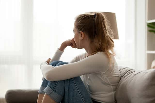 Girl sitting on couch and looking away.