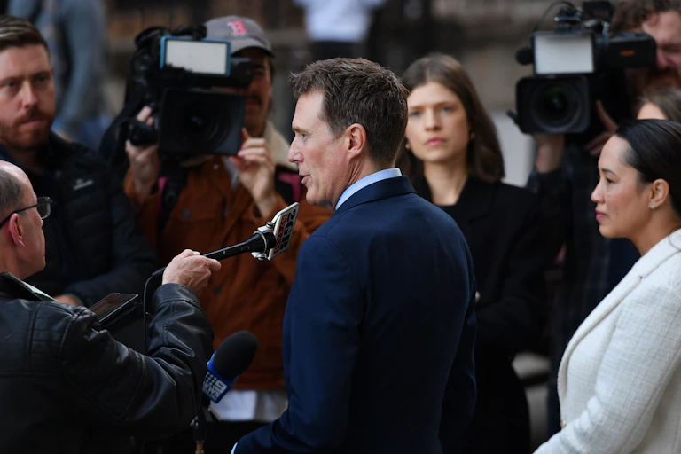 Christian Porter surrounded by journalists