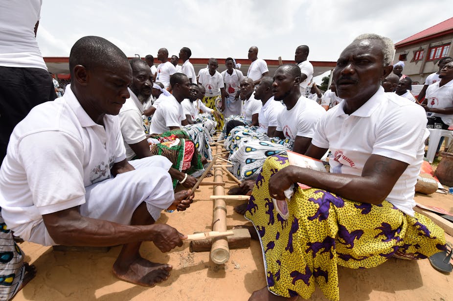 Family size: why some Nigerian men want more children 1 Rows of men seated facing each other over a pole-like instrument, and holding drumsticks
