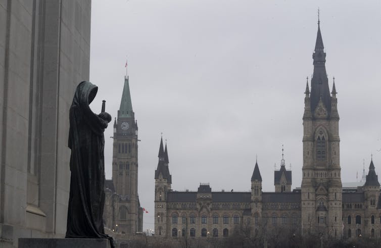The statue representing justice looks out from the Supreme Court of Canada
