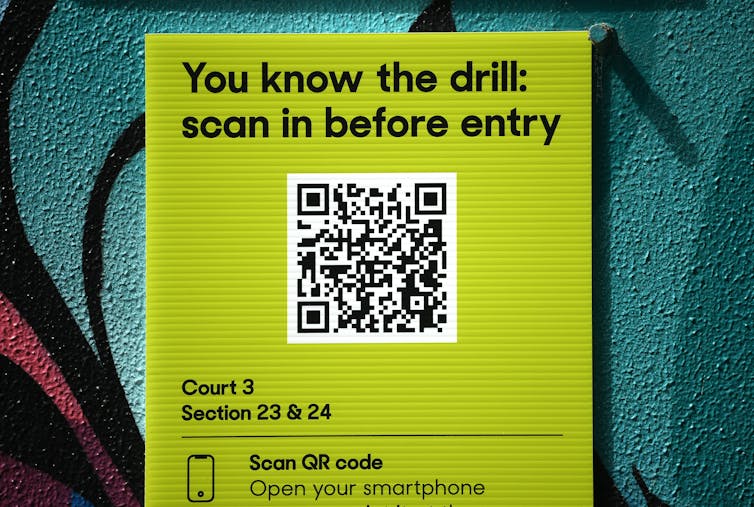 A sign showing a QR code is displayed.