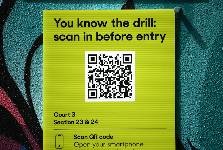 A sign showing a QR code is displayed.