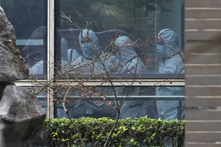 Members of a WHO team in a China lab.