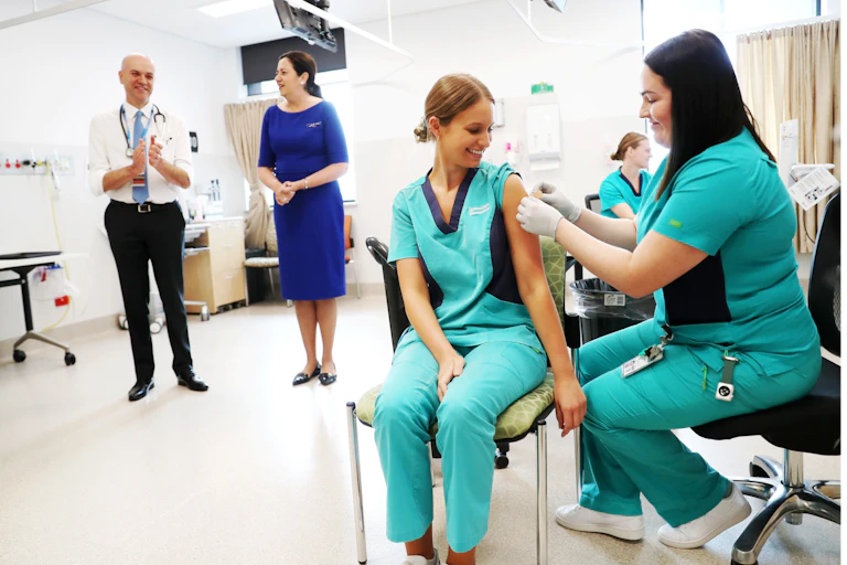 Nurse being vaccinated for COVID-19