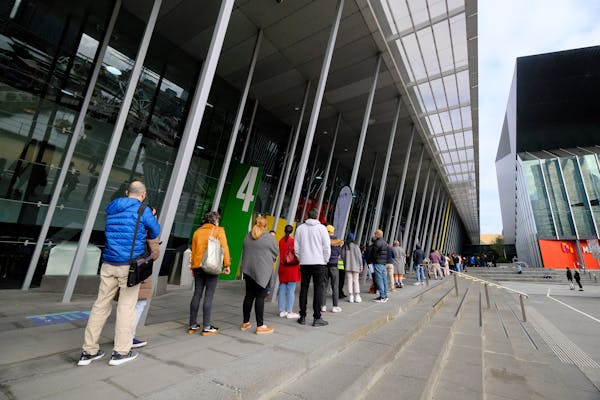 People line up for vaccinations outside the Melbourne Convention and Exhibition Centre.