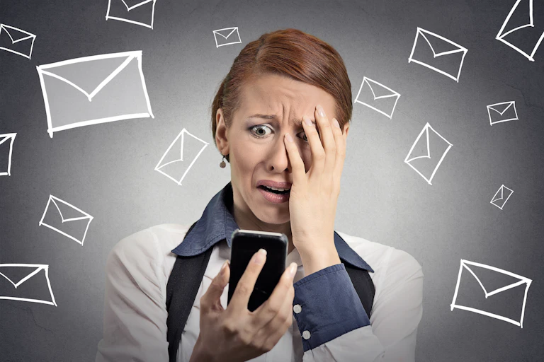 A woman looking worried at her phone surrounded by illustrations of envelope icons