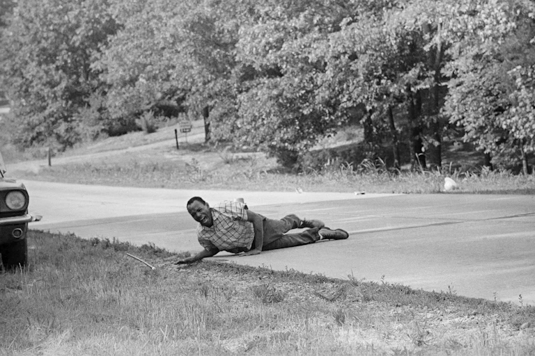James Meredith, shouting with pain as he pulling himself across the street after being shot