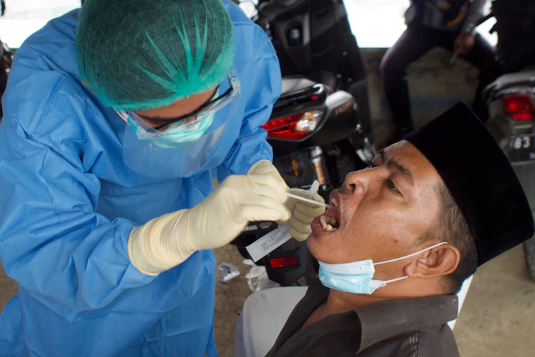 Man receiving COVID test swab