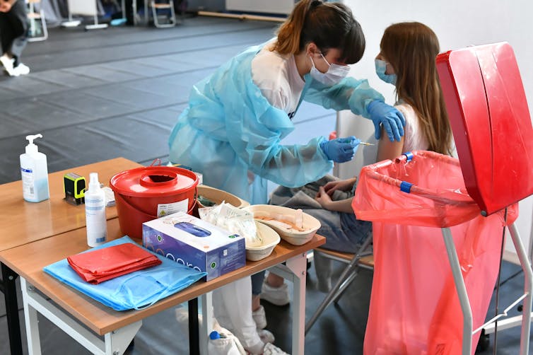 A Polish woman being vaccinated against COVID-19.