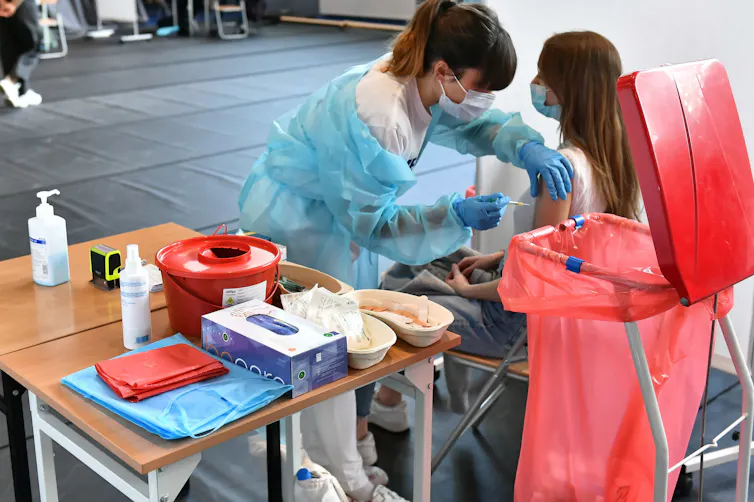A Polish woman being vaccinated against COVID-19.