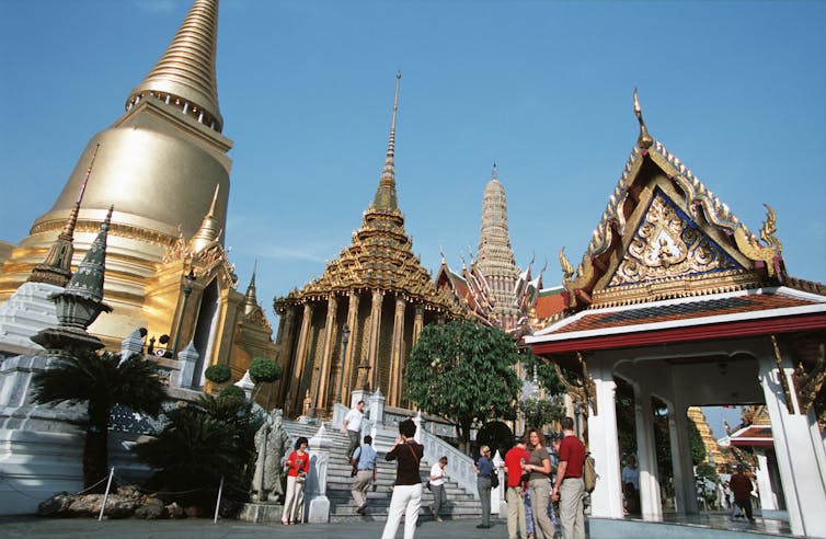 Visitors enjoy the magnificent views of Wat Phra Kaew, temple of the emerald buddha, which is situated in Bangkok's Grand Palace