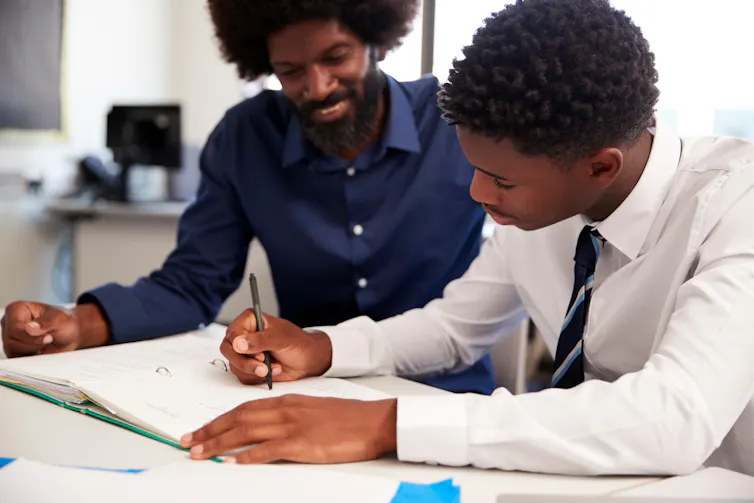 A secondary school pupil does a lesson with a tutor