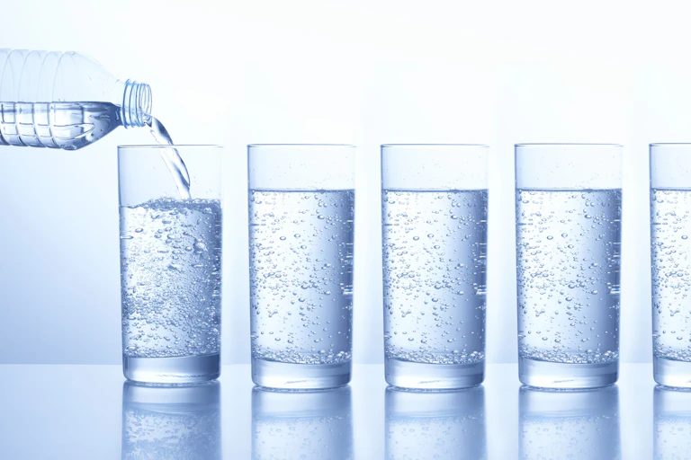 A line of glasses filled with water.