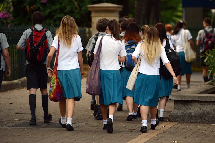 school students walking along a path