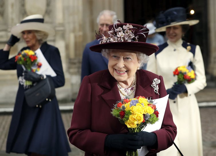 The queen leaves Westminster Abbey, followed by Camilla, Prince Charles and Princess Anne.