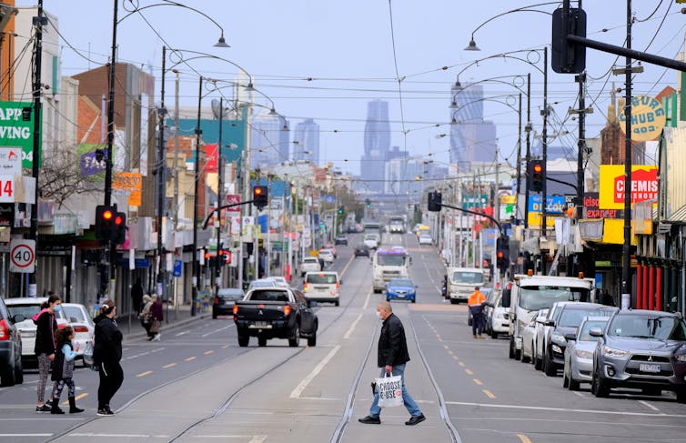 Pedestrians cross Sydney Road in Melbourne's Coburg during lockdown.