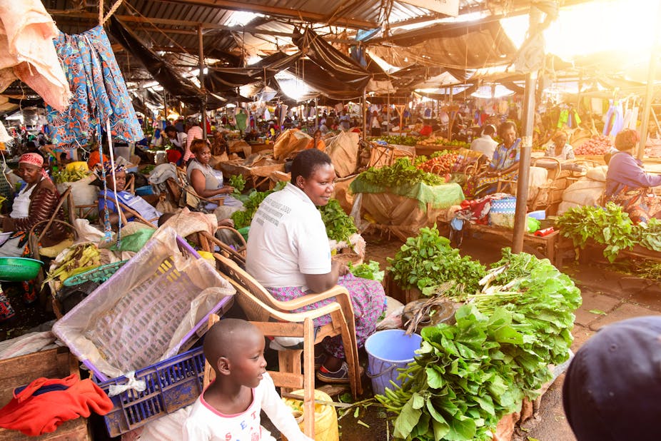 Vendors sell fruits and vegetables at an informal food market.