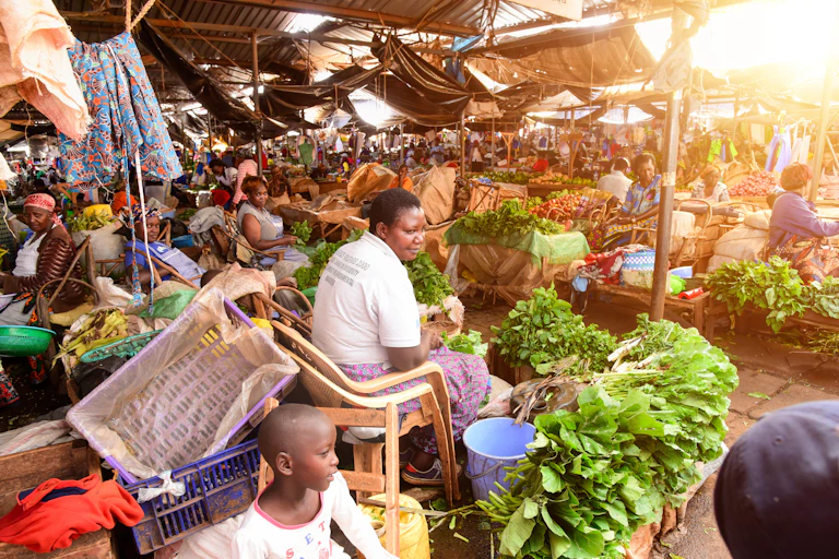 Vendors sell fruits and vegetables at an informal food market.