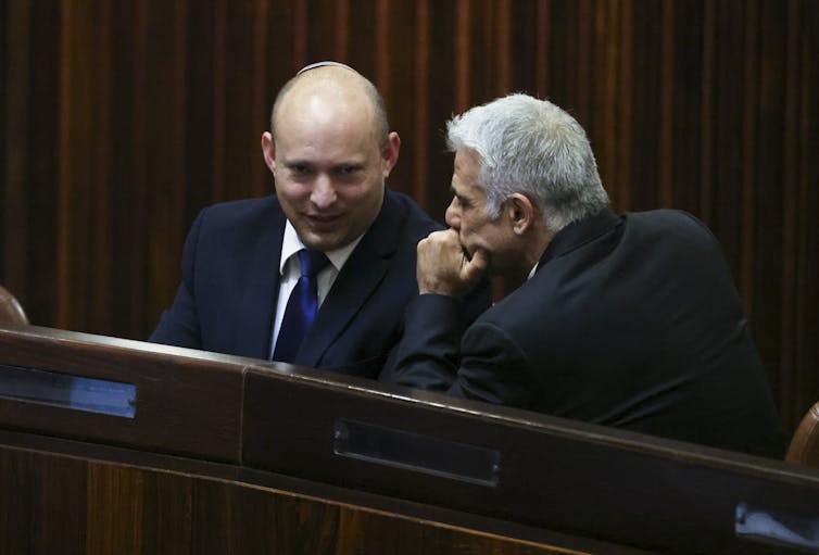 Naftali Bennett and Yair Lapid, the new Israeli coalition leaders, in close conversation.