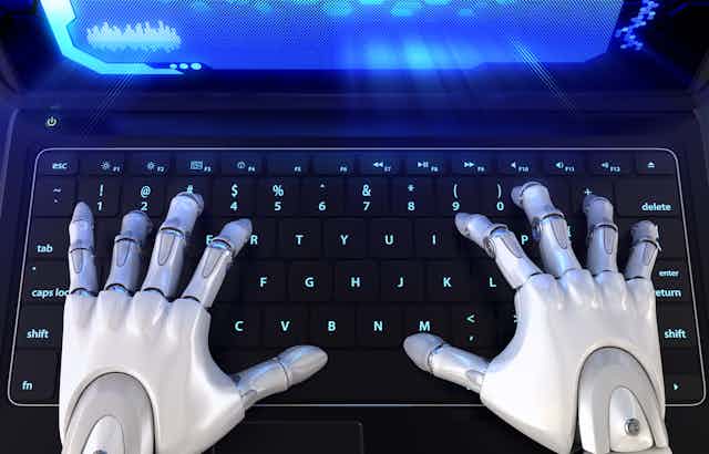 human-like robot hands on a laptop keyboard