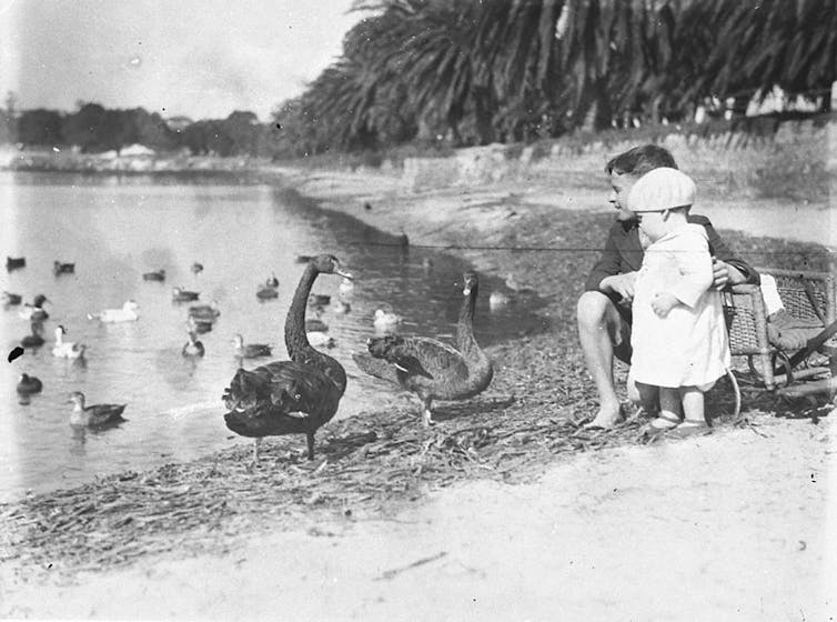 black and white photo of kids at lake with birds
