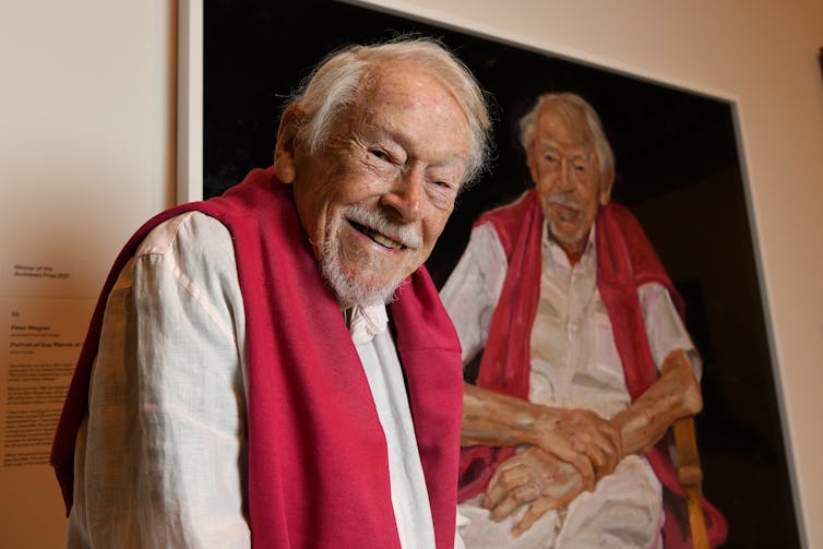 older man with portrait of him