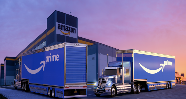 Shot of Amazon lorries outside an Amazon warehouse