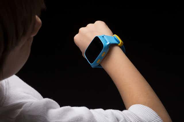 A child looking at a smart watch