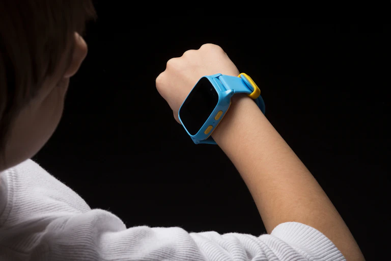 A child looking at a smart watch