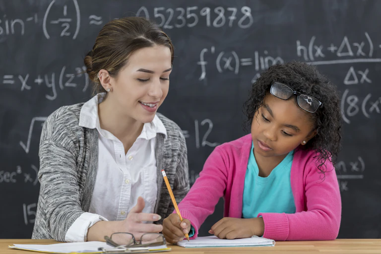 A teacher and student work together on an assignment.