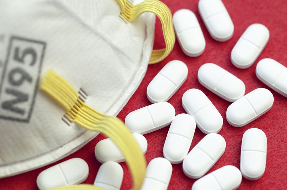 A single N95 face mask along with several prescription painkillers.