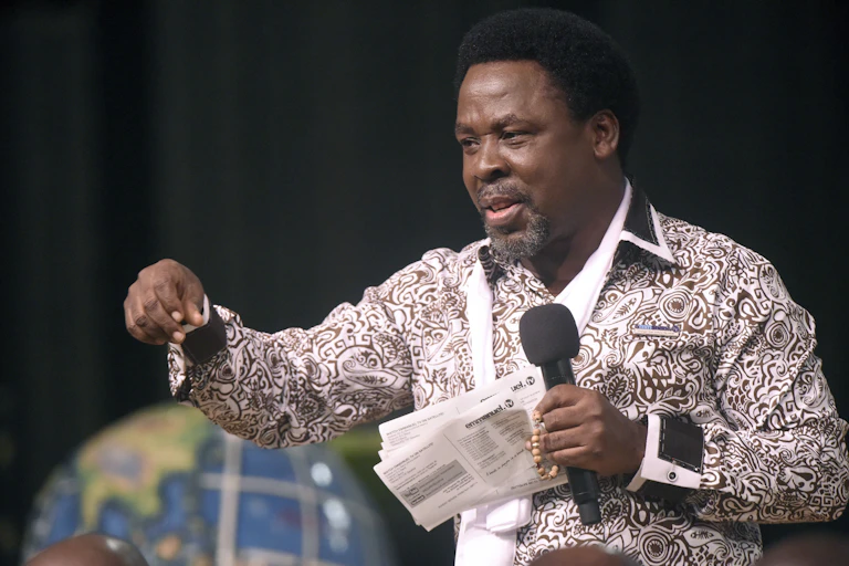 A man with a micrpohone pointing