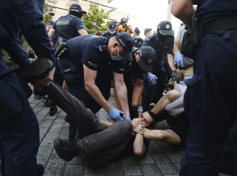 Police scuffle with LGBTQ protesters in Poland.