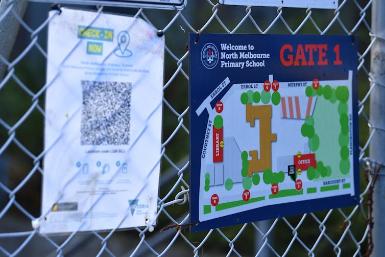 Signs on the gate of North Melbourne Primary School.