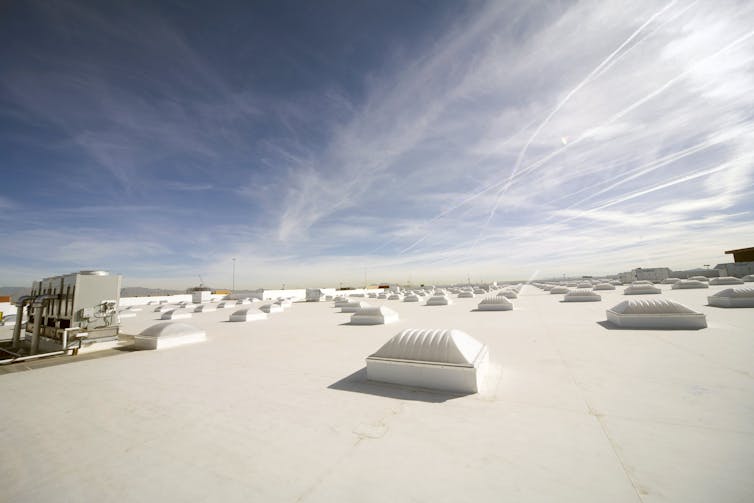 A white roof with skylights under the sky