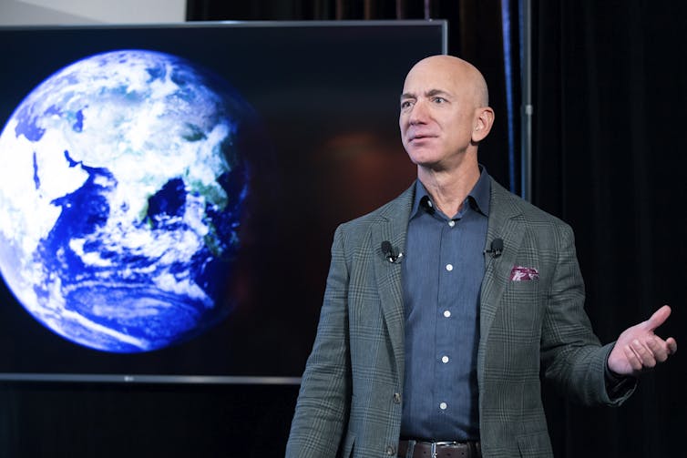 Jeff Bezos in front of an image of the Earth