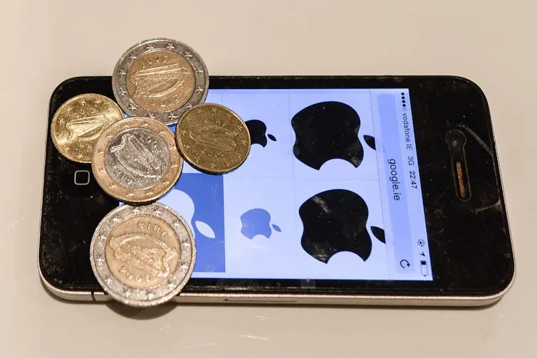 An iPhone with some euro coins on top of it