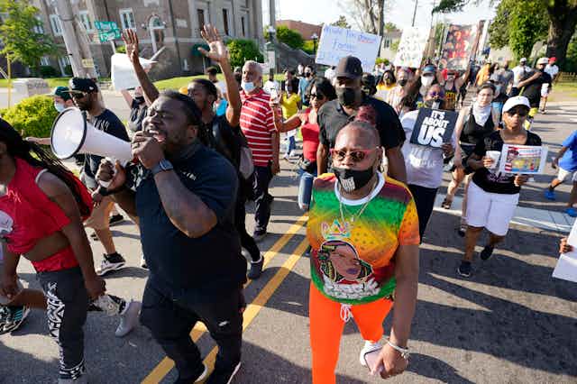 A group of people protesting the police shooting of Andrew Brown Jr., marching  along South Road in Elizabeth City, North Carolina.
