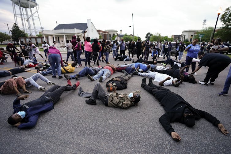Protesters lying on the ground near the county sheriff's office and the Camden Causeway Bridge in Elizabeth City.
