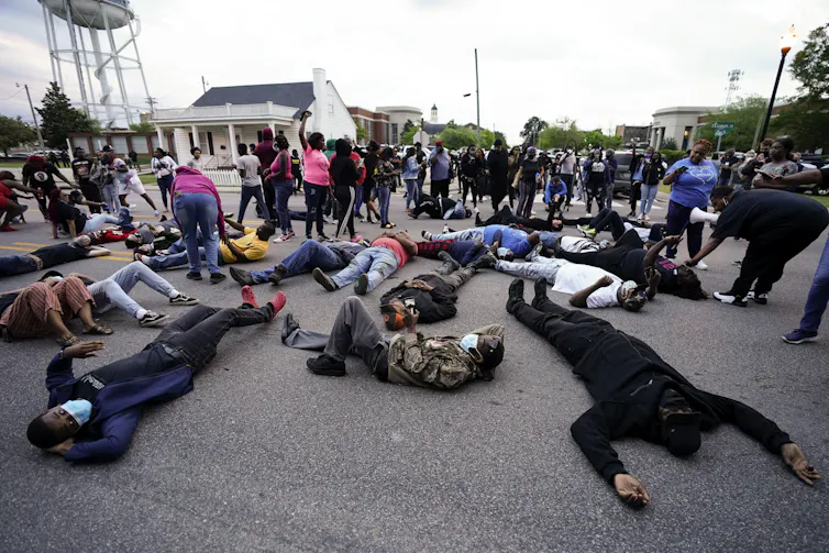 Protesters lying on the ground near the county sheriff's office and the Camden Causeway Bridge in Elizabeth City.